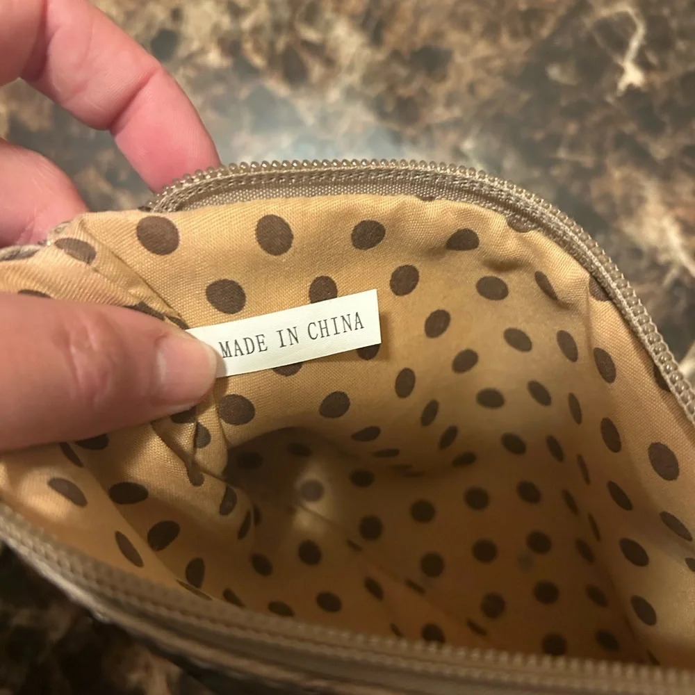 Beige Ostrich textured wristlet with polka dot lining